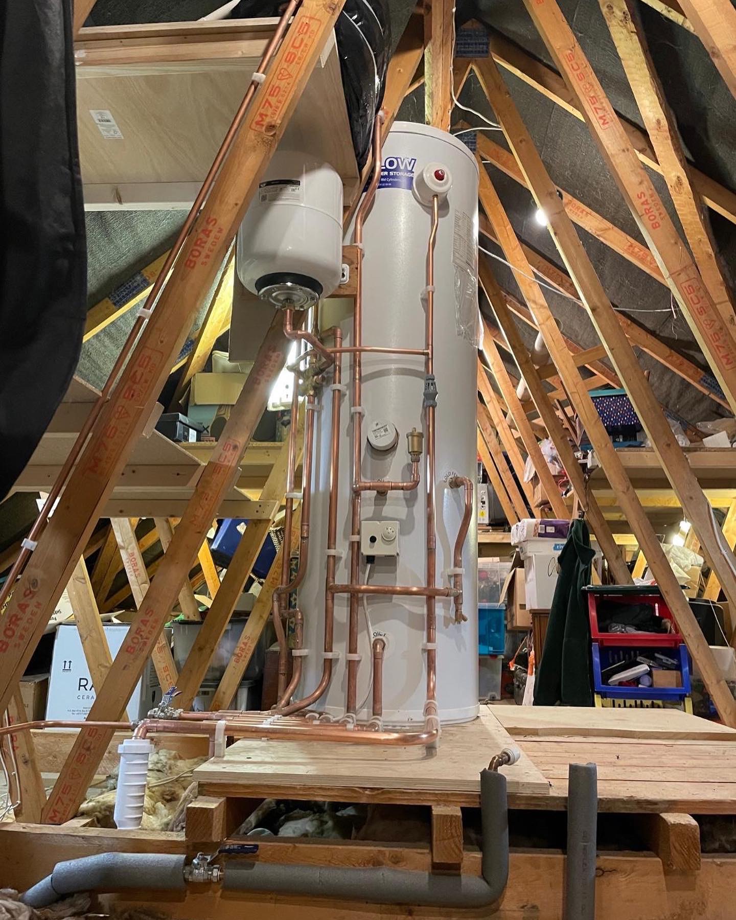 An unvented hot-water cylinder installed in a loft space, with clean copper runs supporting a full system upgrade.